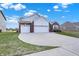 Beautiful exterior view of a home with a wide driveway and lush green grass at 1347 Shaw Ln, Shelbyville, IN 46176