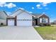 Charming single-story home with brick accents, a spacious driveway, and a well-manicured lawn at 1347 Shaw Ln, Shelbyville, IN 46176