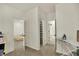 Hallway leading to bedrooms, featuring an ironing board and neutral paint at 1347 Shaw Ln, Shelbyville, IN 46176