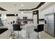 Modern kitchen boasts stainless steel appliances, a spacious island with bar seating, and updated cabinetry at 1347 Shaw Ln, Shelbyville, IN 46176
