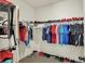 Organized walk-in closet with extensive shelving and hanging space for optimal storage and convenience at 1347 Shaw Ln, Shelbyville, IN 46176