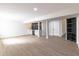 Finished basement with bar area, light wood flooring, recessed lighting, and access to the utility area and stairs at 1351 Sullivans Rdg, Zionsville, IN 46077