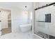 Bright bathroom featuring a freestanding tub, a walk-in shower and tiled floors at 1351 Sullivans Rdg, Zionsville, IN 46077