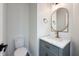Stylish half bath with marble countertop, bronze faucet, and oval mirror at 1351 Sullivans Rdg, Zionsville, IN 46077