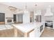 Bright kitchen with a large island, stainless steel appliances, and an open view to the living room with a fireplace at 1351 Sullivans Rdg, Zionsville, IN 46077