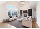 Bright living room featuring high ceilings, large windows, fireplace, and modern chandelier at 1351 Sullivans Rdg, Zionsville, IN 46077