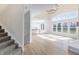 Spacious living room with cathedral ceiling, hardwood floors, large windows, and open layout to the kitchen at 1351 Sullivans Rdg, Zionsville, IN 46077