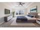Modern main bedroom with tray ceilings, a large window, and stylish furniture at 1351 Sullivans Rdg, Zionsville, IN 46077