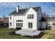 Back exterior showcasing a two-story white home, a wood deck and a well-manicured lawn at 1351 Sullivans Rdg, Zionsville, IN 46077