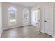 Neutral room with light vinyl floors featuring arch windows and doors at 1351 Sullivans Rdg, Zionsville, IN 46077