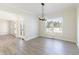 Neutral room with light vinyl floors and modern chandelier at 1351 Sullivans Rdg, Zionsville, IN 46077