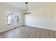 Neutral room with light vinyl floors and modern chandelier at 1351 Sullivans Rdg, Zionsville, IN 46077