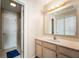 Bright bathroom featuring a single sink vanity, large mirror, and a shower/tub combination at 1568 Brookfield Cir, Franklin, IN 46131