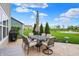 Stamped concrete patio with dining set overlooking a green lawn and pond at 15752 Matthews Ln, Noblesville, IN 46060