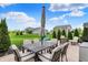 Outdoor dining set with seating for six is featured on the concrete patio and green lawn at 15752 Matthews Ln, Noblesville, IN 46060