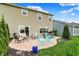 Stamped concrete patio with outdoor seating, set against a two-story house and green lawn at 15752 Matthews Ln, Noblesville, IN 46060