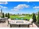 Outdoor seating overlooks a pond and green space in this tranquil backyard setting at 15752 Matthews Ln, Noblesville, IN 46060