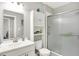 Clean bathroom with walk-in shower, white vanity and cabinets, and a mirrored wall at 15752 Matthews Ln, Noblesville, IN 46060