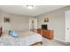 Bedroom with light grey walls, neutral carpet, bed, dresser, and connecting door at 15752 Matthews Ln, Noblesville, IN 46060