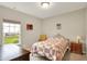 Cozy bedroom with a traditional iron bed frame, a window with a view of the yard, and neutral paint at 15752 Matthews Ln, Noblesville, IN 46060