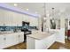 Open kitchen layout with island, stainless appliances, and mosaic backsplash at 15752 Matthews Ln, Noblesville, IN 46060