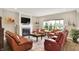 Spacious living room with a fireplace, leather furniture, and a view of the backyard at 15752 Matthews Ln, Noblesville, IN 46060