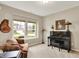 Cozy living room featuring a piano, comfortable seating, and natural light from large windows at 15752 Matthews Ln, Noblesville, IN 46060