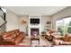 Inviting living room features a fireplace, large windows, and comfortable seating at 15752 Matthews Ln, Noblesville, IN 46060