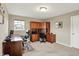 Spacious home office with built-in desk and cabinets, neutral carpet, and large windows at 15752 Matthews Ln, Noblesville, IN 46060