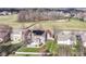An aerial view of a home with a well-manicured lawn, stone patio, solar panels and nearby walking path at 15898 Bounds Dr, Noblesville, IN 46062
