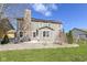 A spacious backyard featuring a stone patio, a stone chimney and solar panels on the roof at 15898 Bounds Dr, Noblesville, IN 46062