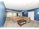 Cozy basement living room featuring plush seating, neutral carpet, and a projector for entertainment at 15898 Bounds Dr, Noblesville, IN 46062