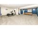 Finished basement with exercise equipment, media space, and comfortable seating for entertainment at 15898 Bounds Dr, Noblesville, IN 46062