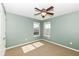 A bright bedroom with two windows and natural light and a ceiling fan at 15898 Bounds Dr, Noblesville, IN 46062