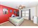 Bedroom featuring a bright red accent wall, window, and ceiling fan at 15898 Bounds Dr, Noblesville, IN 46062