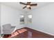 Bright bedroom with wood floors, a chair, two windows and a ceiling fan at 15898 Bounds Dr, Noblesville, IN 46062
