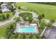 Aerial view of a community pool and park with a playground, surrounded by lush greenery and neighborhood streets at 15898 Bounds Dr, Noblesville, IN 46062