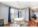 Bright dining area with hardwood floors, a round table, and a large window with backyard views at 15898 Bounds Dr, Noblesville, IN 46062