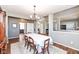 Elegant dining room featuring a classic chandelier, wood floors, and neutral gray paint at 15898 Bounds Dr, Noblesville, IN 46062