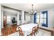 Cozy dining room with a large window, wood floors, and comfortable seating at 15898 Bounds Dr, Noblesville, IN 46062