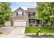 Charming two-story home featuring a stone facade, three-car garage, and well-manicured front yard at 15898 Bounds Dr, Noblesville, IN 46062