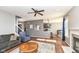 Open-concept living room featuring hardwood floors, a fireplace, and contemporary furniture at 15898 Bounds Dr, Noblesville, IN 46062