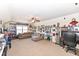 Spacious living room with a comfortable couch, ceiling fan, and shelves displaying memorabilia at 15898 Bounds Dr, Noblesville, IN 46062