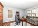 Well-lit office space with wood floors, neutral walls, and comfortable seating area at 15898 Bounds Dr, Noblesville, IN 46062