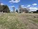 View of the expansive open grassy acreage, outbuilding, and single story home from the rear at 17245 N 200 E, Summitville, IN 46070