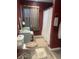 Bathroom with classic decor, including a vanity, toilet, and curtained shower, creates a cozy, functional space at 17245 N 200 E, Summitville, IN 46070