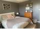 Cozy bedroom with a plush bed, decorative pillows, and a wooden dresser offers a restful and stylish retreat at 17245 N 200 E, Summitville, IN 46070