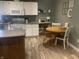 Bright eat-in kitchen featuring white cabinets, stainless steel appliances, and modern vinyl flooring at 17245 N 200 E, Summitville, IN 46070