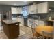 A fully equipped kitchen with stainless steel appliances, center island, and table with chairs at 17245 N 200 E, Summitville, IN 46070