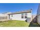 This backyard includes a concrete patio and ample lawn space, perfect for relaxation at 1850 Blue Pine Ln, Indianapolis, IN 46231